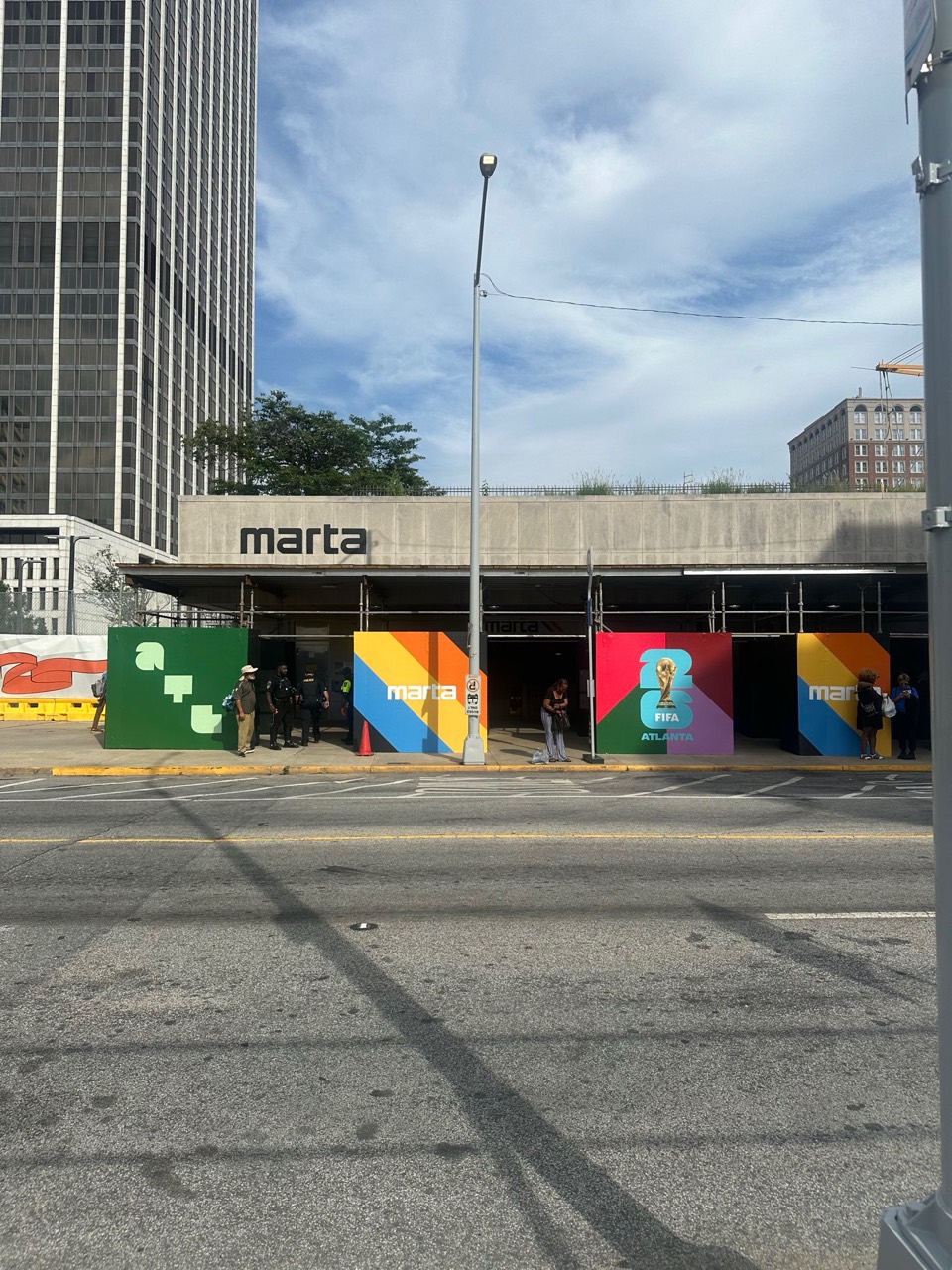 Street-level view of MARTA signage at Five Points station in downtown Atlanta with FIFA Atlanta panels near the entrance.