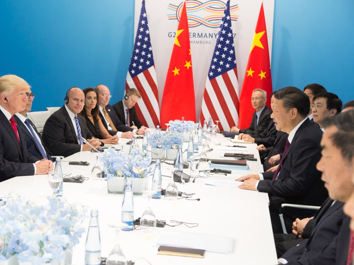 Trump and Xi seated with advisers during a bilateral meeting at the 2017 G20 summit.