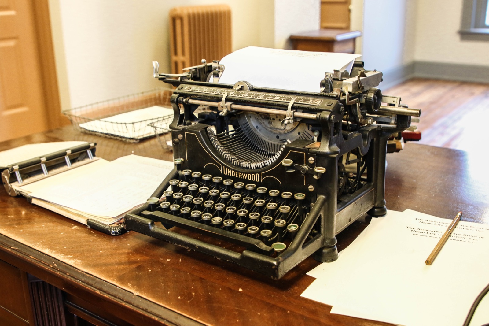 Underwood typewriter and papers on a desk at the Carter G. Woodson Home National Historic Site.