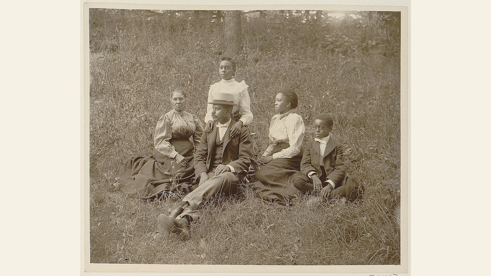 An African American family posed outdoors on a lawn in Georgia around 1899 or 1900.